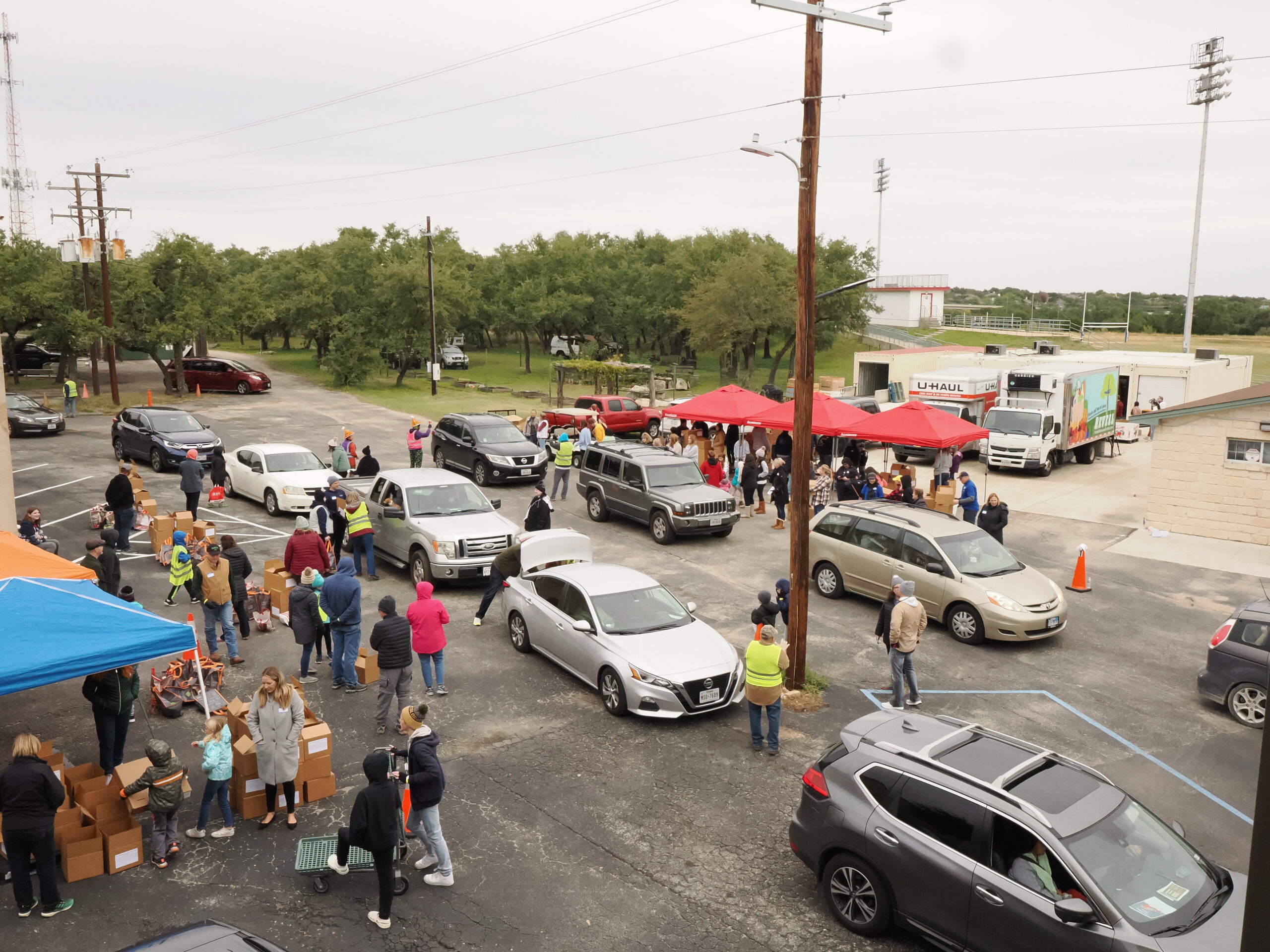 Vehicles lined up at a Reveal food distribution.